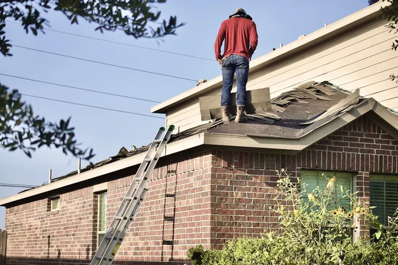 Professional roofer working on a residential roof in Waco